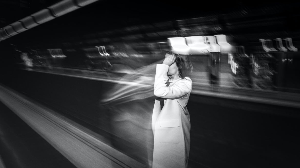 Faceless woman waiting for metro cabin in subway