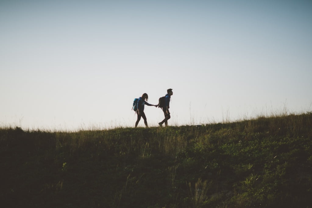 trust, crush your challenges, couple walking on hill while holding during daytime