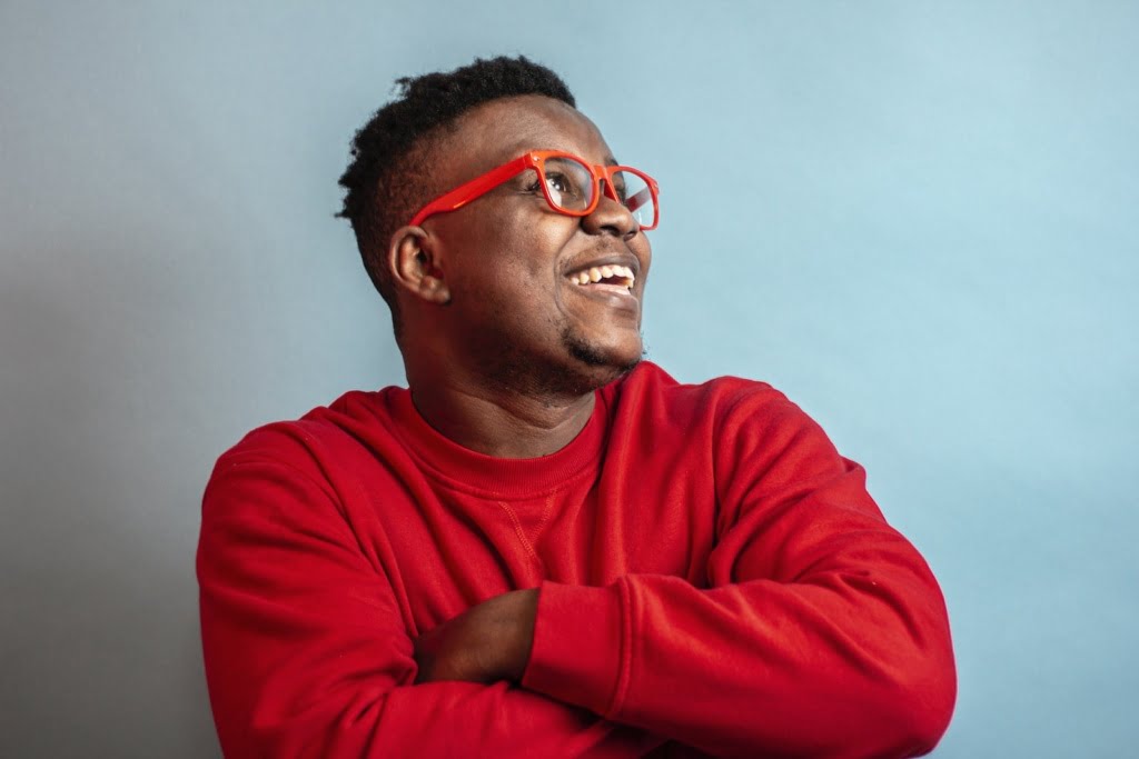 stay positive, man in red sweater wearing black framed eyeglasses