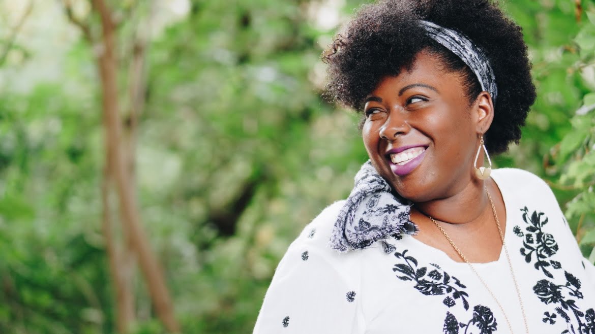 smiling woman looking on right side during daytime