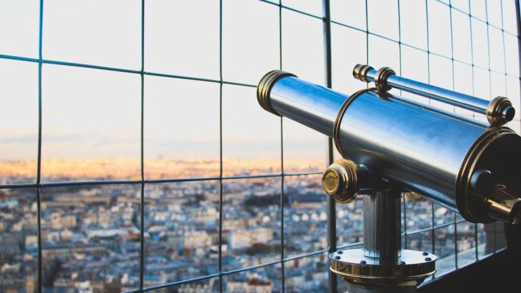 silver telescope near fence